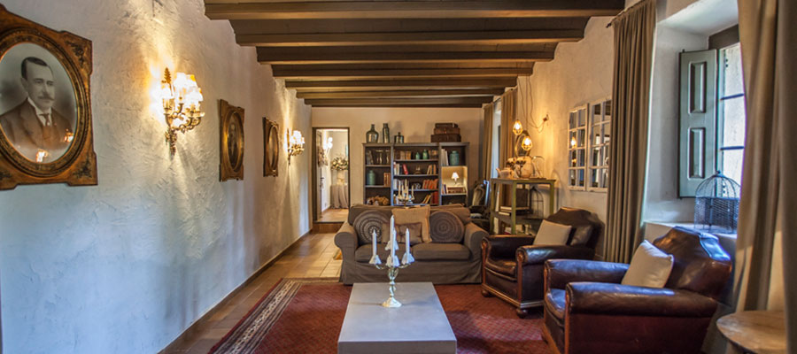 nosotros-2 sala con vigas en el techo, sillones y mesas